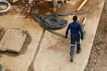 worker is carry the cart from the scrap metal