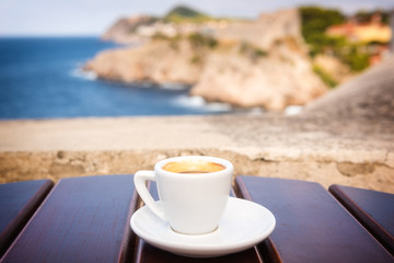 Cup of coffee on the ancient city wall of Dubrovnik Old Town view, relax cityscape background in soft light, Dalmatia, Croatia
