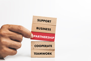 Businessman Building PARTNERSHIP concept with Wooden Blocks