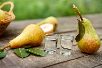 Fresh pears with peers brandy on table