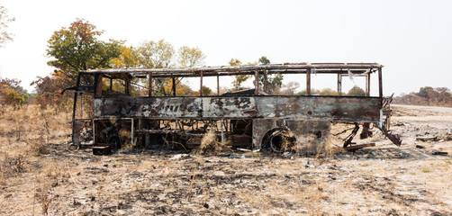 Obraz premium Burned bus at the side of the road