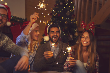 Friends holding sparklers at New Year's Eve midnight