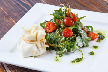 Salad with cherry tomatoes and Arugula with cheese bag