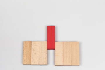 Arranging wood block stacking red block in the middle. Ladder career path.