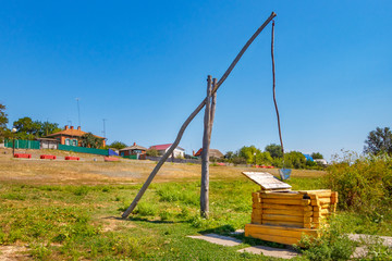 The wooden draw-well with the crane in the village. Russia, Rostov-on-Don region, stanitsa Kazanskaya
