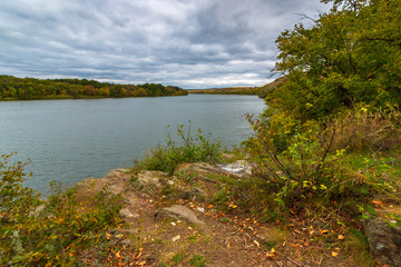 The stormy landscape with overcast sky and the flat river. River Seversky Donets, Russia,...