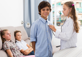 Fototapeta premium Doctor girl in uniform with stethoscope