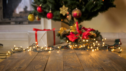 Perfect backgorund for Christmas and winter celebrations. Wooden table against decorated Christmas...