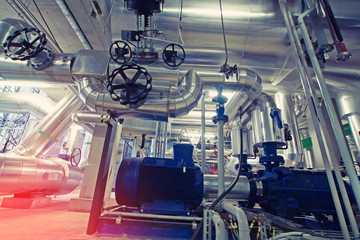 Equipment, cables and piping as found inside of a modern industrial power plant.