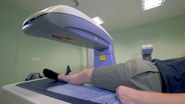 Scanning process of a male patient carried out by an MRI machine