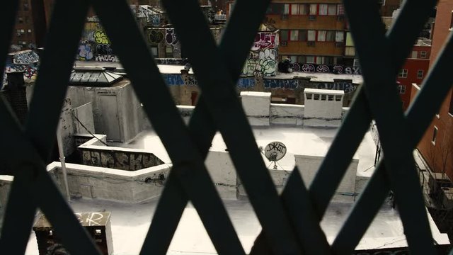 A Window View of Rooftops and Graffit on a new York Morning.