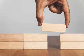 Fotobehang Tower Bridge Man solving problems by building bridge with wooden block