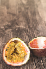 half passion fruit on wooden background,vertical