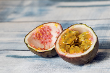 cut passion fruit on blue wooden background
