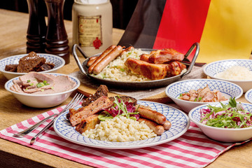 Oktoberfest food menu: sausages, fried bacon, pork ears, salad.