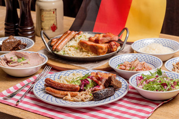 Oktoberfest food menu: sausages, fried bacon, pork ears, salad.