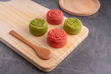 Red and green Mid-Autumn festival mooncakes are displayed