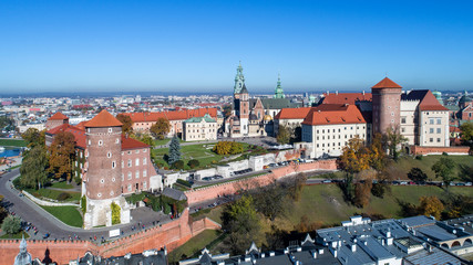 Fototapeta na wymiar Royal Wawel Gothic Cathedral in Cracow, Poland, with Renaissance Sigismund Chapel with golden dome, Wawel Castle, yard, park and tourists. Aerial view in autumn.