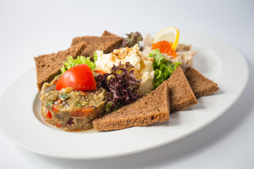 Roasted toasts with aubergine paste and red caviar