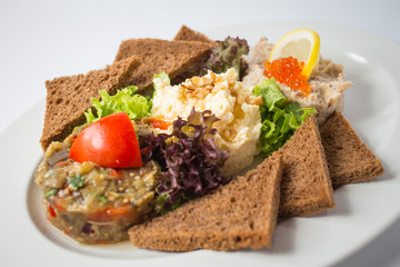 Roasted toasts with aubergine paste and red caviar