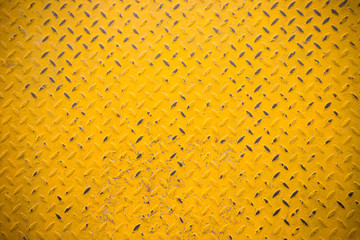 yellow grungy metal sheet background and texture with dark vignette. yellow steel floor panel.