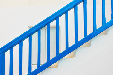 Blue staircase with wooden railing