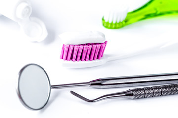 dental care toothbrush with dentist tools on white background