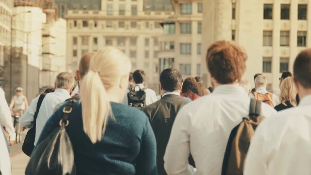 Anonymous crowd walking in a big city street. Commuters rushing to work. 120fps