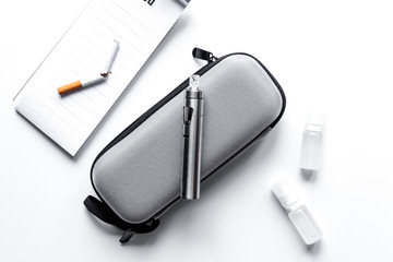 concept of electronic cigarette on white background top view