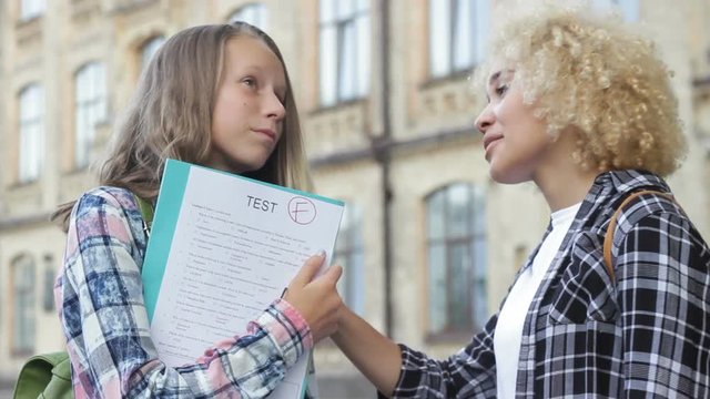Disappointed adolescent girl cry, faling control exam, best girlfriend soothing