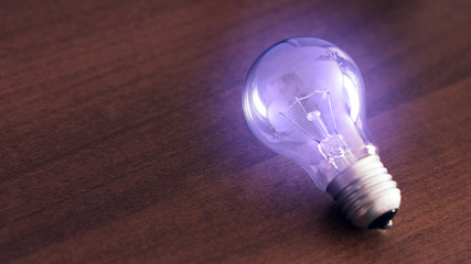 Bulb on wooden table, concept of idea