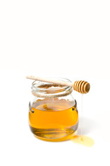 Fototapeta na wymiar Natural fresh honey and honey spoon on white background.