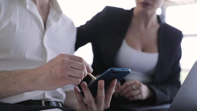 Business Office. Man With Phone And Woman Working At Computer