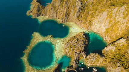 Aerial view: Twin Lagoon with blue, azure water in the middle of small islands and rocks. Beach, tropical island, sea bay and lagoon, mountains with forest, Palawan, Coron. Busuanga. Seascape