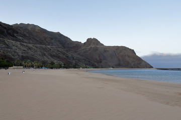 A landscape of the yellow sand and mountains of Playa de Las Teresitas, next to San Andres and Santa Cruz cities, in Tenerife, Canary islands