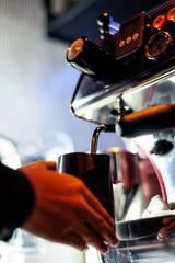 making espresso coffee close up detail with modern machine