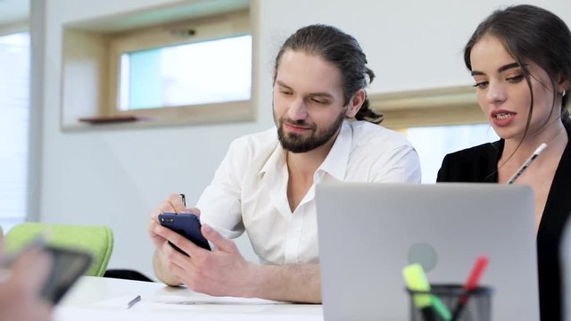 Office. Man Using Phone, Woman Working On Computer At Workplace