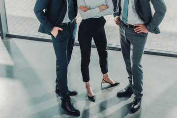 cropped shot of group of male and female business people at modern office