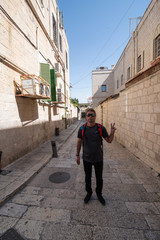 Fototapeta na wymiar Portrait of man showing victory sign in the Old Center of Jerusalem