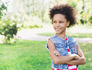 Beautiful kid girl portrait outdoors.  Healthy smiling little girl enjoying life.  Relaxing in nature, summer holidays concept