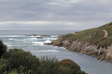 Fototapeta na wymiar Landscape of Tower of Hercules in the Galicia capital city La Coruña on its rocks promontory on the sea