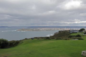 A landscape of a cloudy stormy sea and a grass lawn from Parque de Bens in Galicia capital city La...