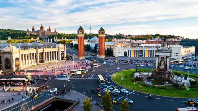 Barcelona, Spain. Spanish Square aerial view in Barcelona, Spain at night. Time-lapse of traffic light trails, fountain and Venetian towers, National museum at the background. Colorful sky, zoom in