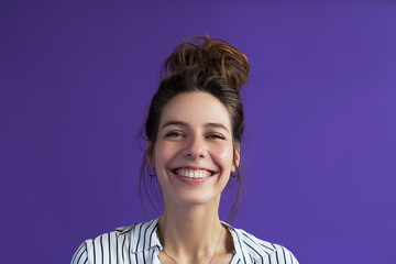 Happy face, wide smile, charismatic girl smiling at the camera, happy eyes. A young woman with a...