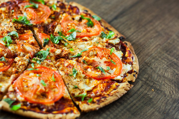 Pizza with Mozzarella cheese, Tomatoes, pepper, Spices and Fresh Basil. Italian pizza. Pizza Margherita or Margarita. on wooden background