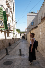 Woman looking back while walking on the streets of Jerusalem