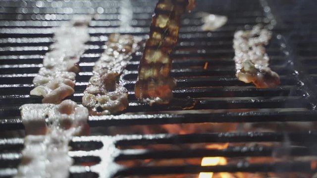 slice of bacon fried on a grill