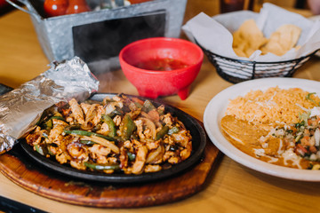 Chicken fajitas with rice, beans ,chips and salsa