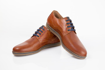 Brown leather shoe on white background.