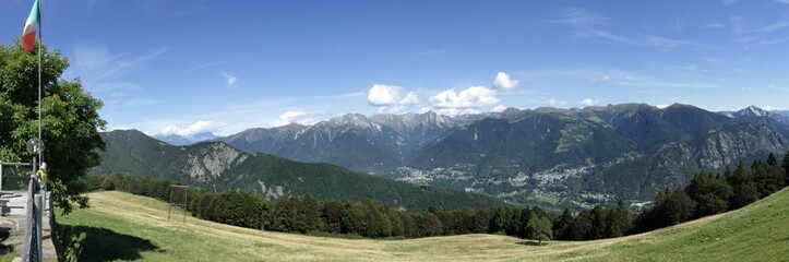 Fototapeta na wymiar A landscape of green mountains, with pines and firs, rocks and glaciers, in the Vigezzo Valley, northern Italian Alps